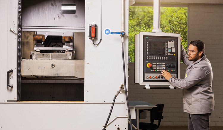 Machinist operating a CNC machining centre at the Hacker plant